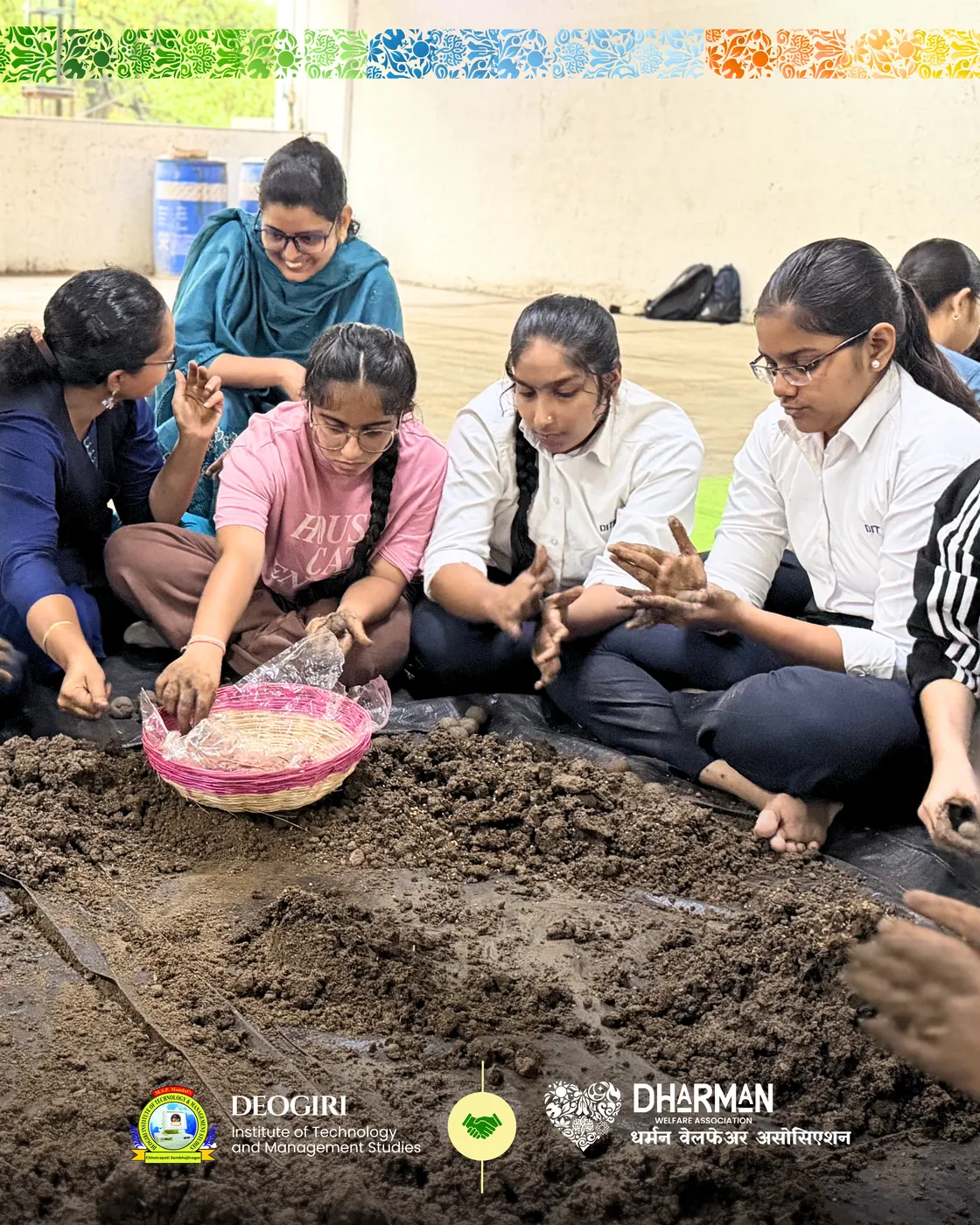 College students seated around basins of soil, making seed balls.