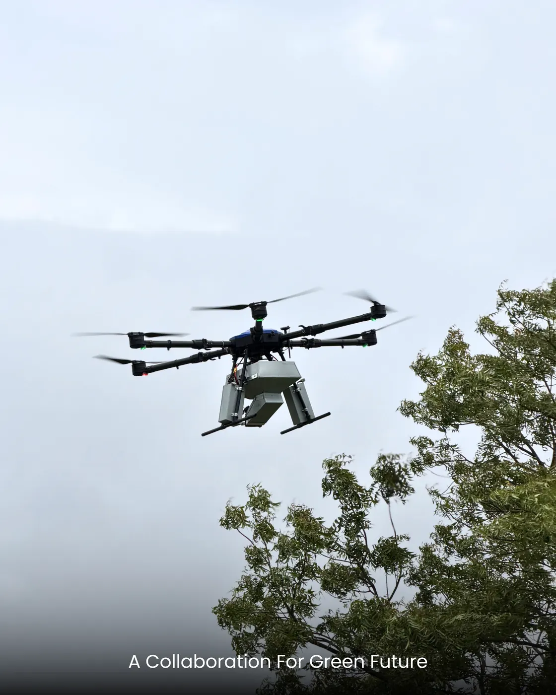 A seed-ball dispersal drone hovering against an overcast sky.