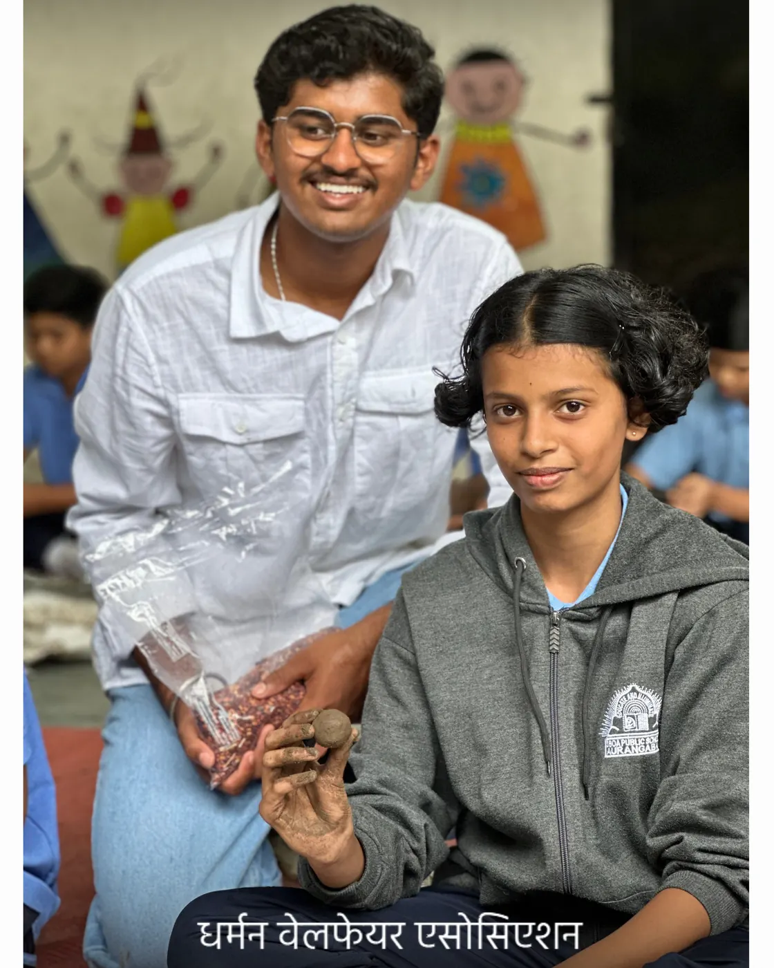 A Dharman volunteer with a student after the workshop.