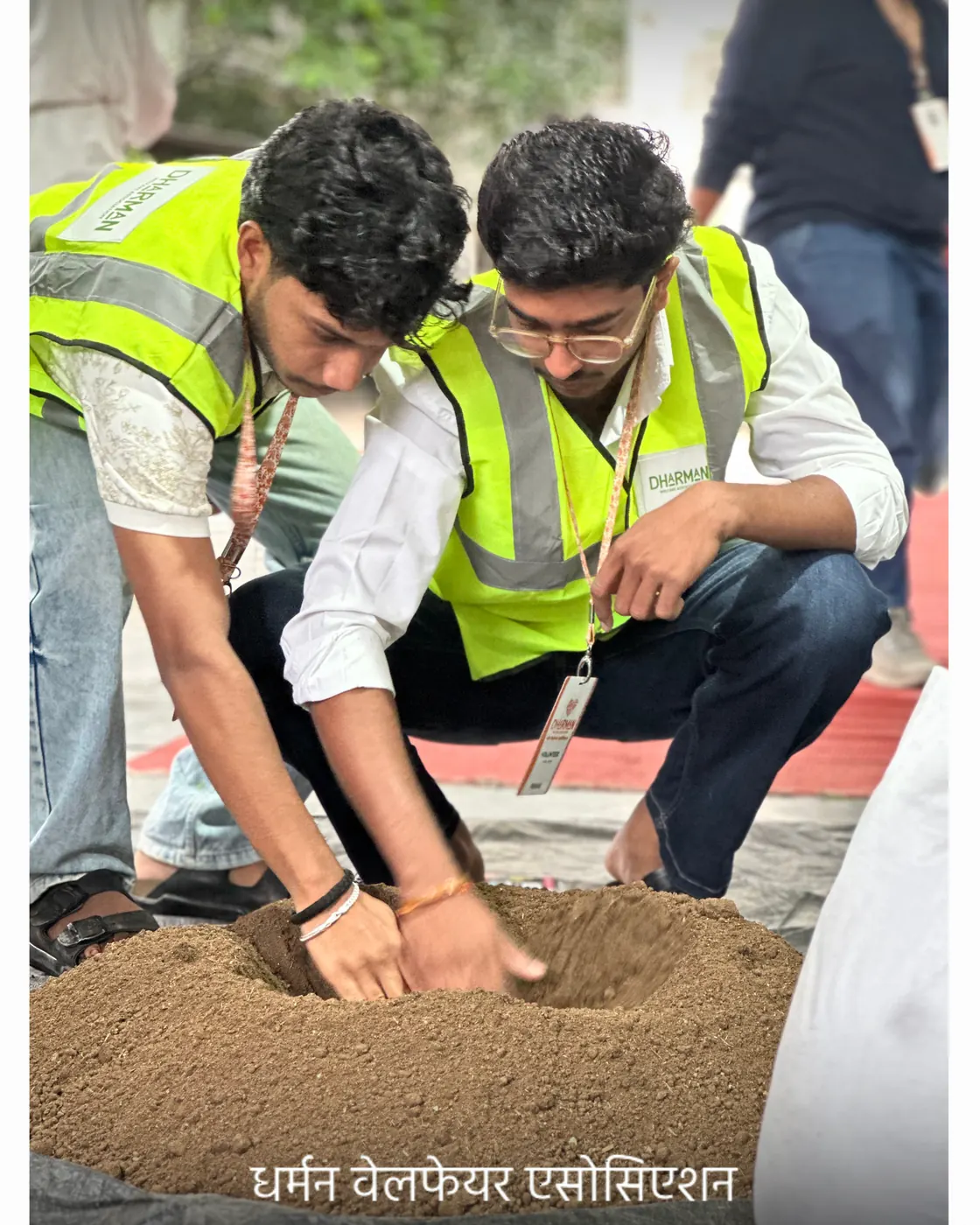 Volunteers and students packing soil for the next batch.