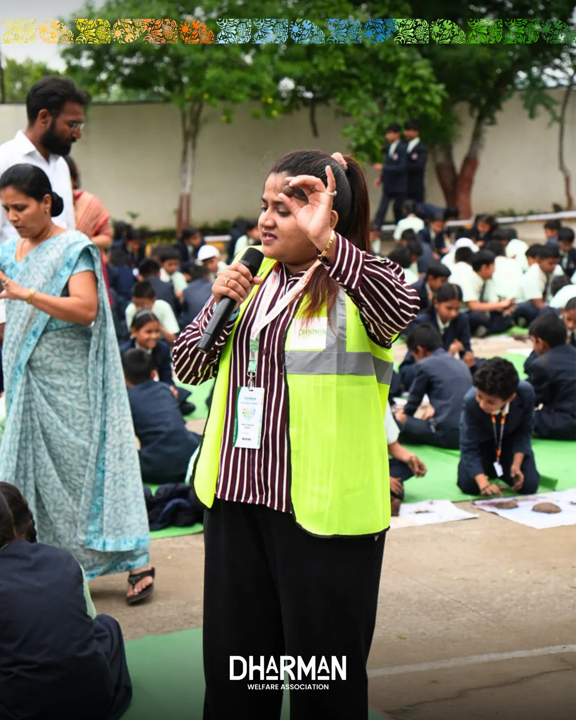 Students in blazers seated together rolling seed balls.