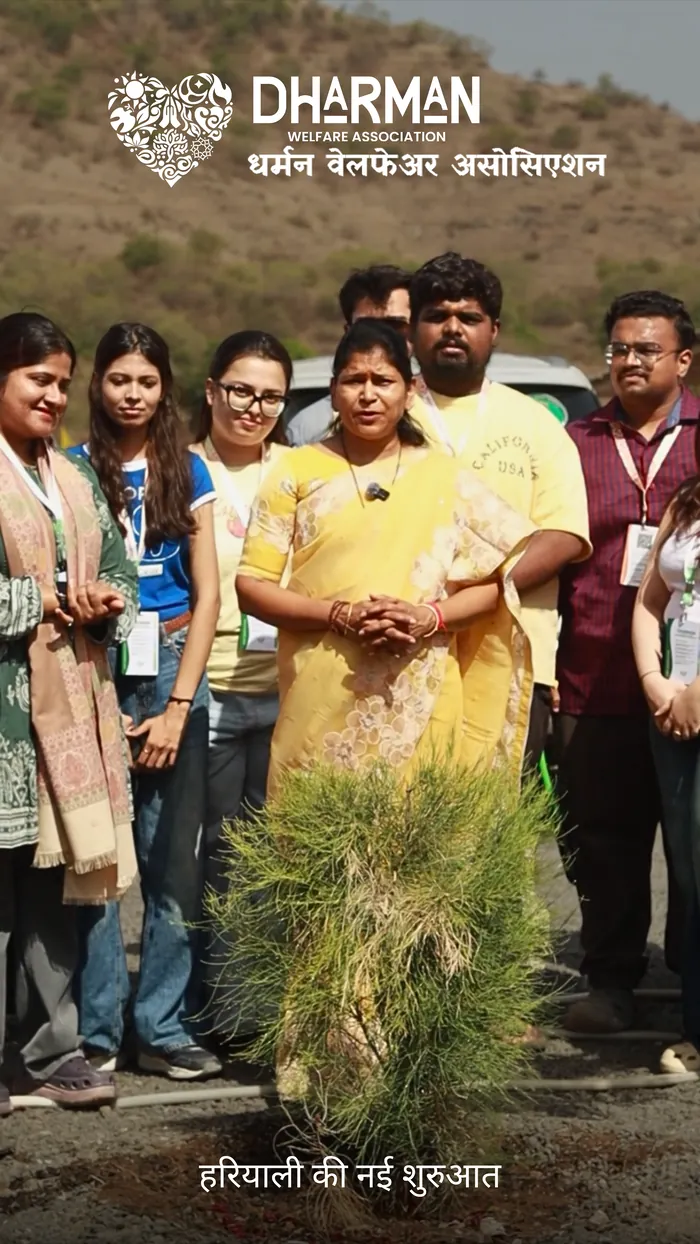 The Dharman team gathered around a newly planted tree.